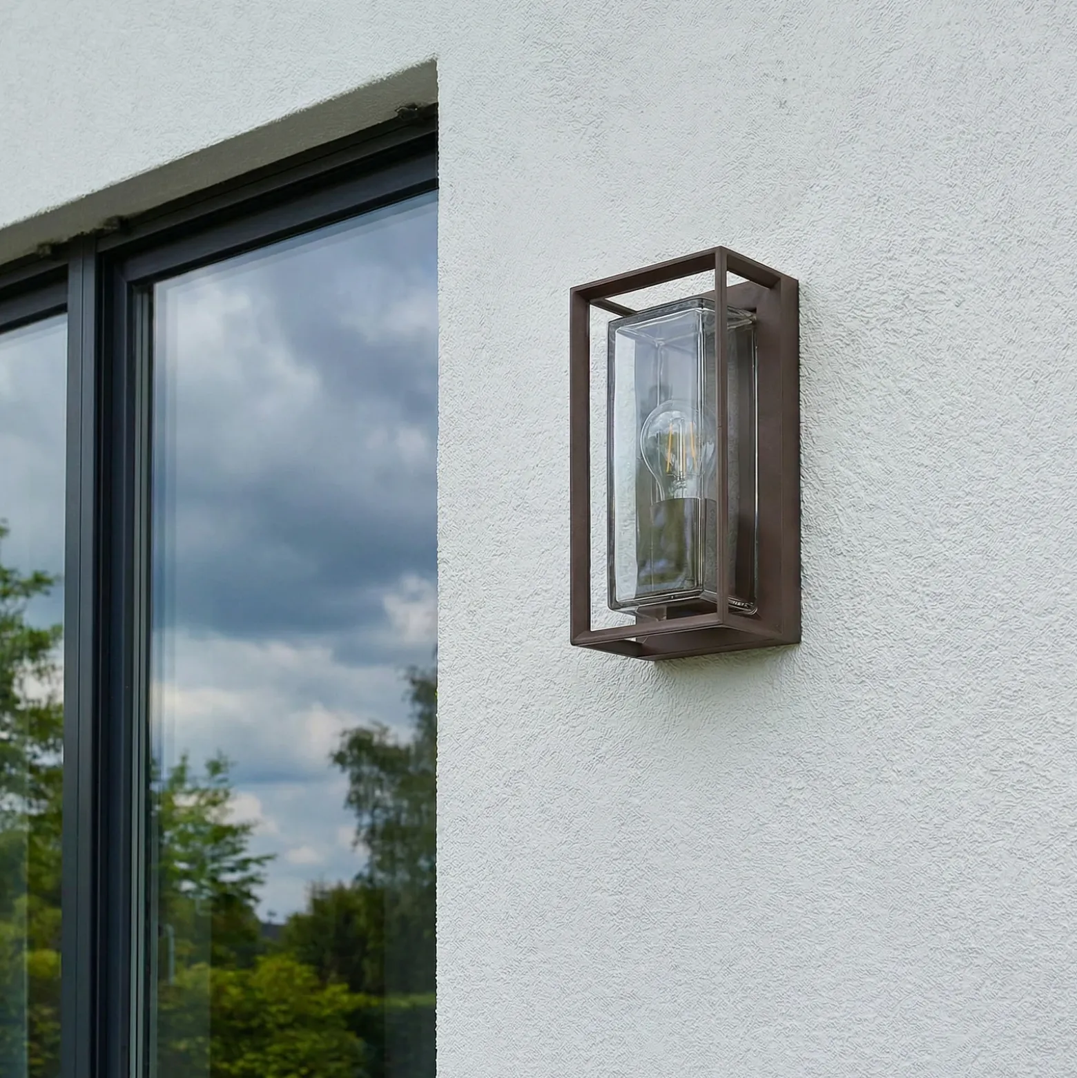 Aplique de exterior Arcchio Ismera, color óxido, IP65, cristal, E27