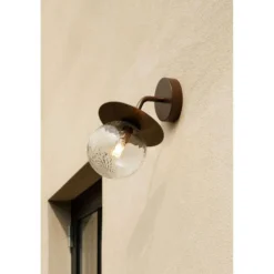 Aplique de exterior Nuura Liila, ancho 16 cm, bronce/transparente
