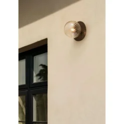 Aplique de exterior Nuura Liila, Ø 16 cm, bronce/transparente