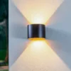 Lámpara de pared LED para exteriores Nivar de Lindby, redonda, negro/dorado,