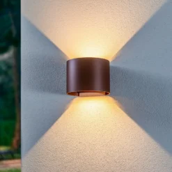 Lámpara de pared LED para exteriores Nivar de Lindby, redonda, óxido, metal,